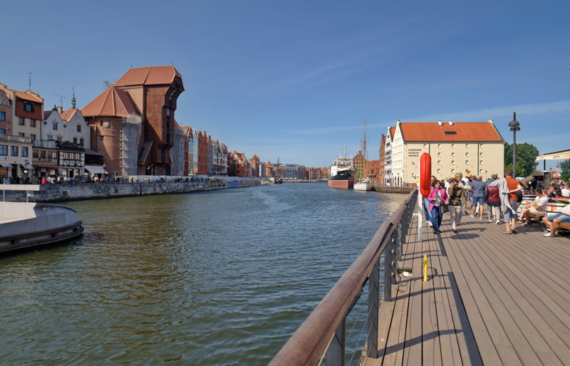 The Motława River embankment in Gdańsk, Poland, featuring the iconic medieval crane, known as the Żuraw